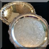 S34. Pair of round silverplate trays. Flat 15” William Rogers plate and footed 16.5” plate. - $40 